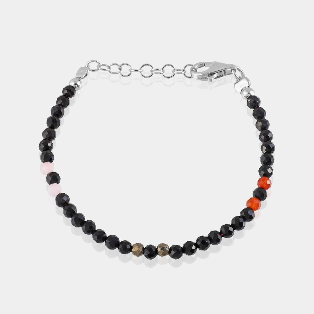 Close-up of faceted round Black Onyx, Carnelian, Pyrite, and Rose Quartz gemstone beads