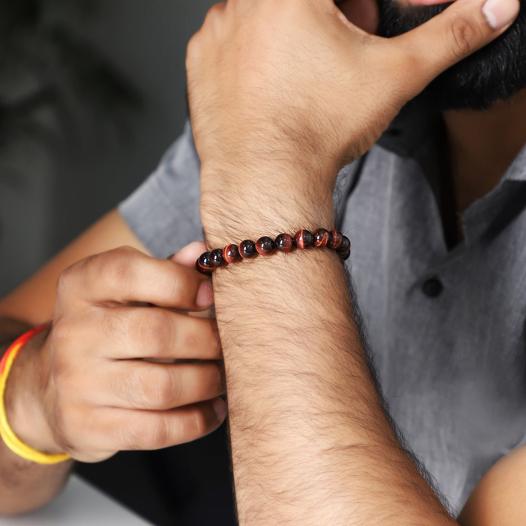 A wrist shot capturing the red tiger's eye bead bracelet worn elegantly, showcasing how the bracelet complements various styles.