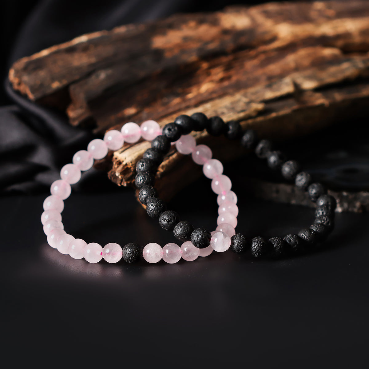 Artistic close-up of the Natural Rose Quartz & Lava Gemstone Bracelet. A captivating shot capturing the soft pink hues of Rose Quartz and the raw elegance of lava gemstones, creating a unique and eye-catching composition