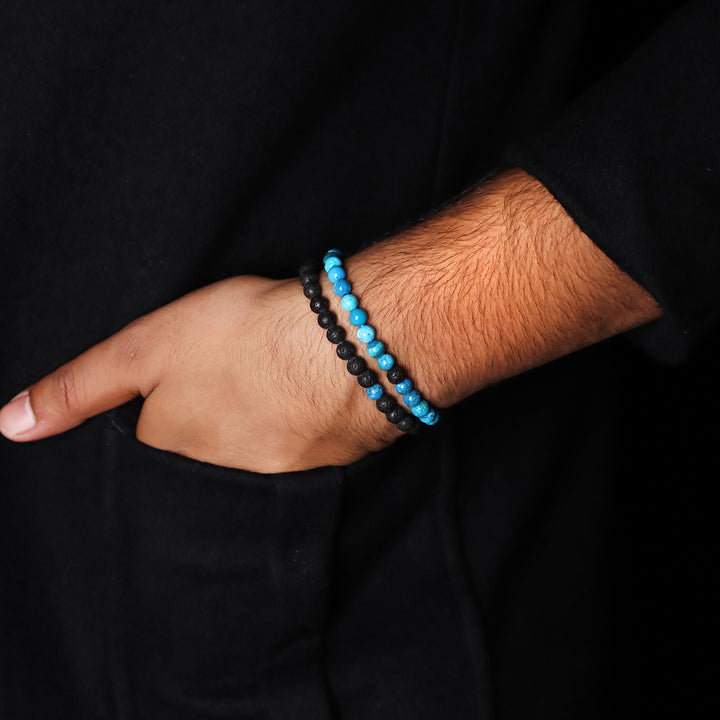 Natural Blue Opaline & Lava Gemstone Bracelet. Emphasis on the wrist, highlighting the 6mm beads for a refined and serene look.