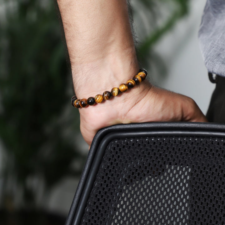 A wrist shot capturing the golden tiger's eye bead bracelet worn elegantly, showcasing how the bracelet complements various styles.