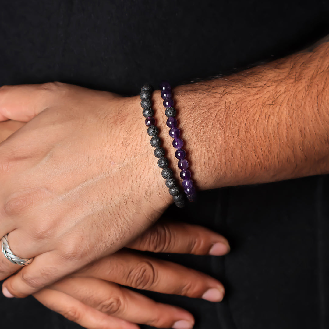 Natural Amethyst & Lava Gemstone Bracelet. Focus on the wrist, highlighting the 6mm beads for a refined and regal look.
