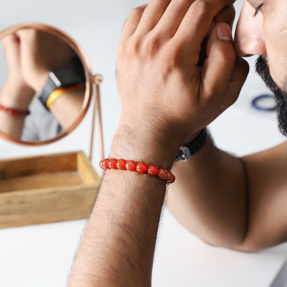 A wrist shot capturing the red onyx bead bracelet worn elegantly, showcasing how the bracelet adds a touch of charm to various styles.