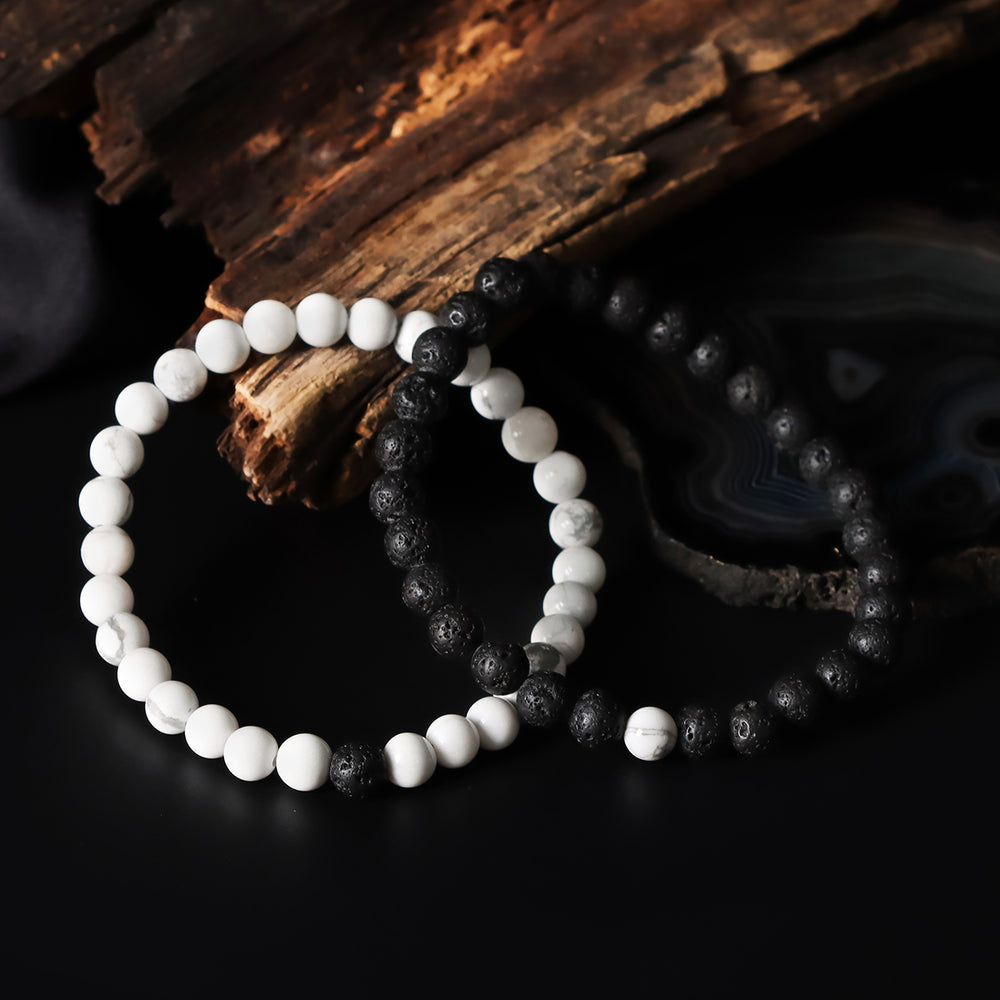 Artistic close-up of the Natural Howlite & Lava Gemstone Bracelet. A captivating shot capturing the serene white hues of Howlite and the raw elegance of lava gemstones, creating a unique and eye-catching composition.