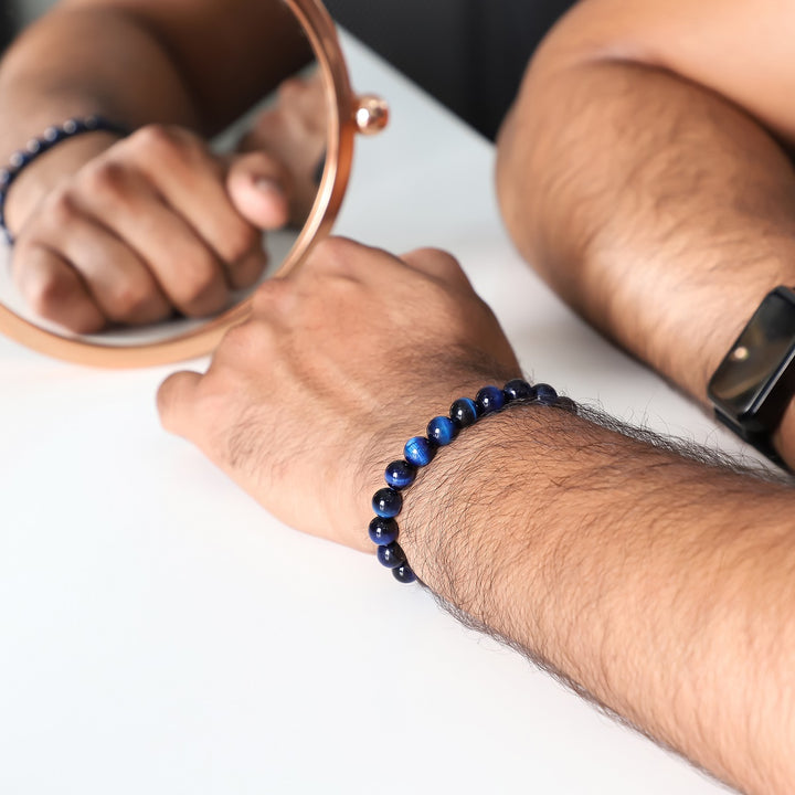 A wrist shot capturing the blue tiger's eye bead bracelet worn elegantly, showcasing how the bracelet complements various styles