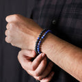 Natural Lapis Lazuli & Lava Gemstone Bracelet. Emphasis on the wrist, highlighting the 6mm beads for a refined and regal look.