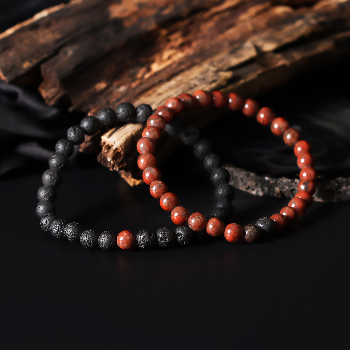 Artistic close-up of the Natural Red Jasper & Lava Gemstone Bracelet. A captivating shot capturing the rich red hues of Jasper and the raw elegance of lava gemstones, creating a unique and eye-catching composition.
