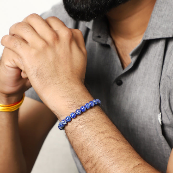 An image featuring the lapis lazuli gemstones alongside keywords like wisdom, communication, and self-awareness, symbolizing their metaphysical properties.