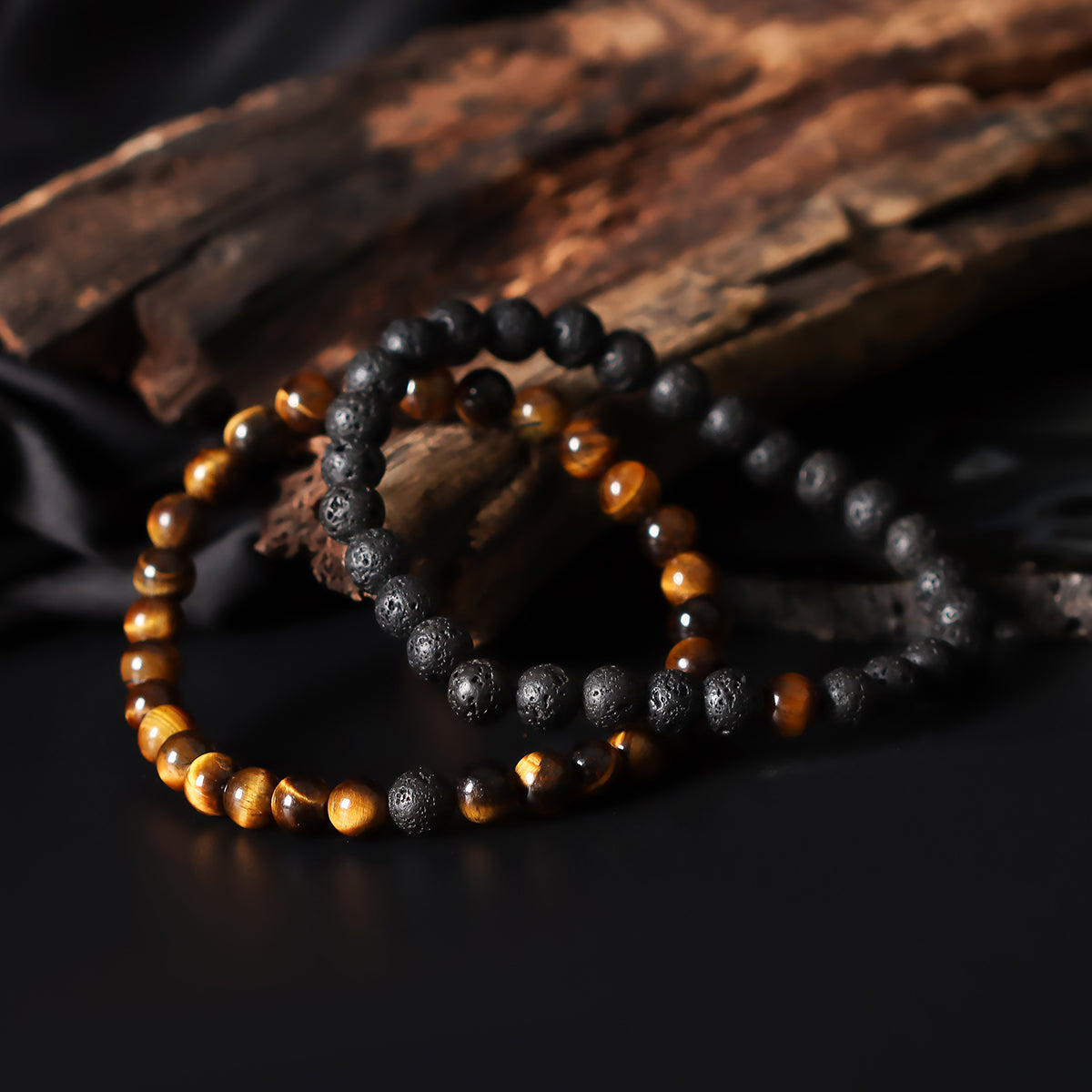 Artistic close-up of the Natural Tiger's Eye & Lava Gemstone Bracelet. A captivating shot capturing the golden hues of Tiger's Eye and the raw elegance of lava gemstones, creating a unique and eye-catching composition.