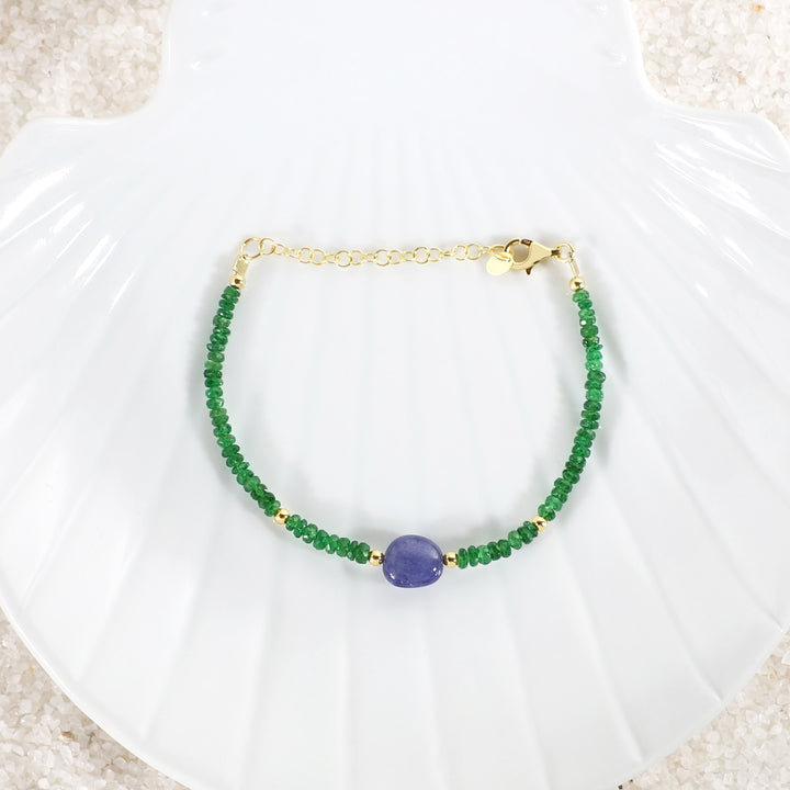 Bracelet captured in natural light, revealing the brilliant colors of the Tsavorite and Tanzanite gemstones against the sterling silver backdrop