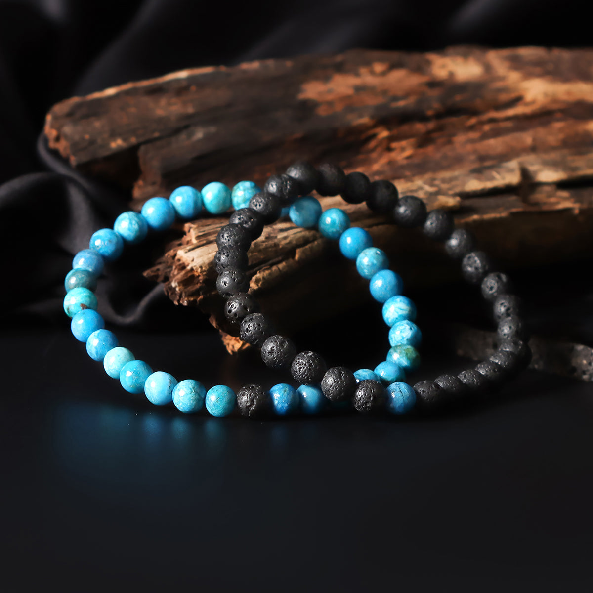 Artistic close-up of the Natural Blue Opaline & Lava Gemstone Bracelet. A captivating shot capturing the tranquil blue hues of Opaline and the raw elegance of lava gemstones, creating a unique and eye-catching composition.