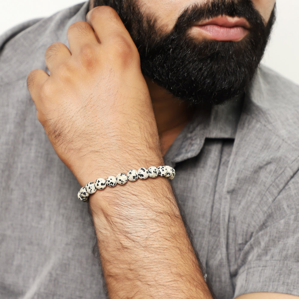 A wrist shot capturing the Dalmatian jasper bead bracelet worn elegantly, showcasing how the bracelet adds a touch of charm to various styles.