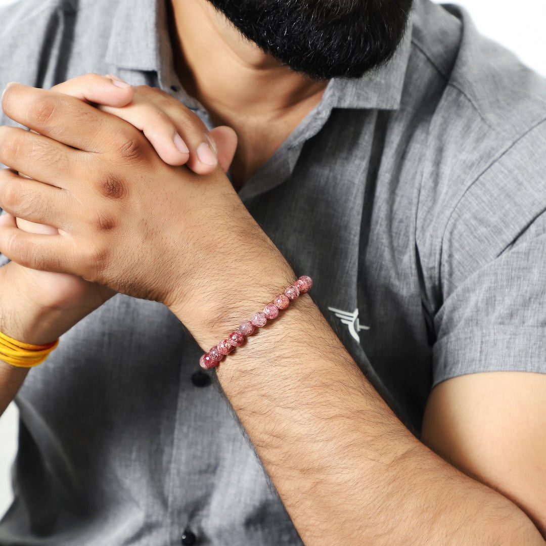 A wrist shot capturing the strawberry quartz bead bracelet worn elegantly, showcasing how the bracelet enhances various styles.