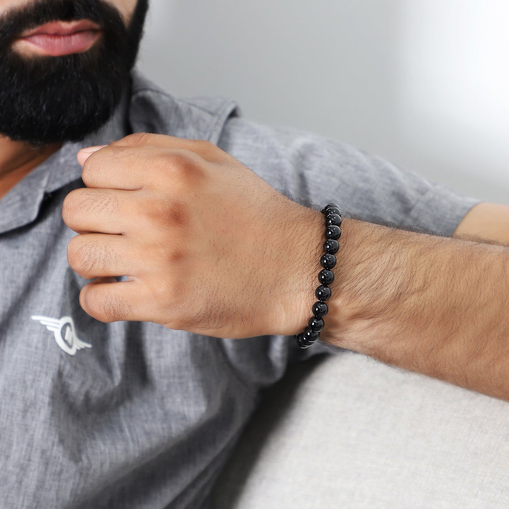 Different sizes of the black onyx bead bracelet laid out, offering options for a perfect fit on any wrist