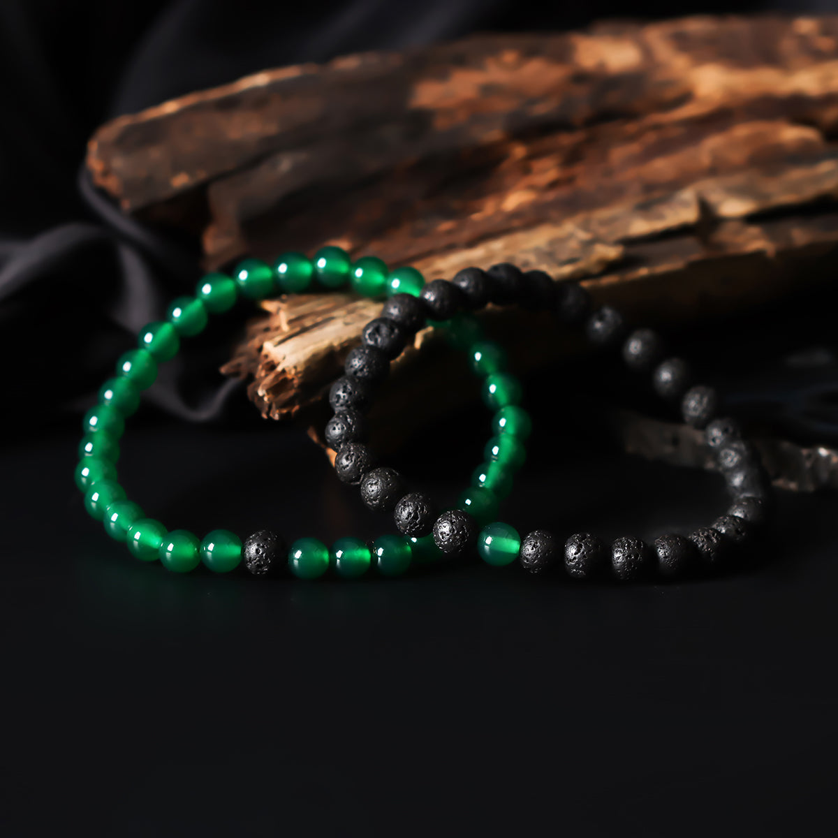 Artistic close-up of the Natural Green Onyx & Lava Gemstone Bracelet. A captivating shot capturing the soothing green hues of Onyx and the raw elegance of lava gemstones, creating a unique and eye-catching composition.