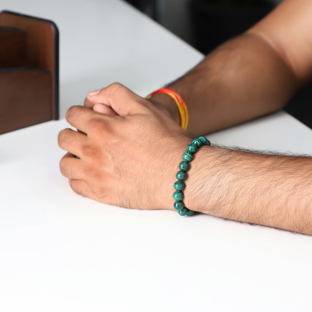 A wrist shot capturing the malachite bead bracelet worn elegantly, showcasing how the bracelet complements various styles.