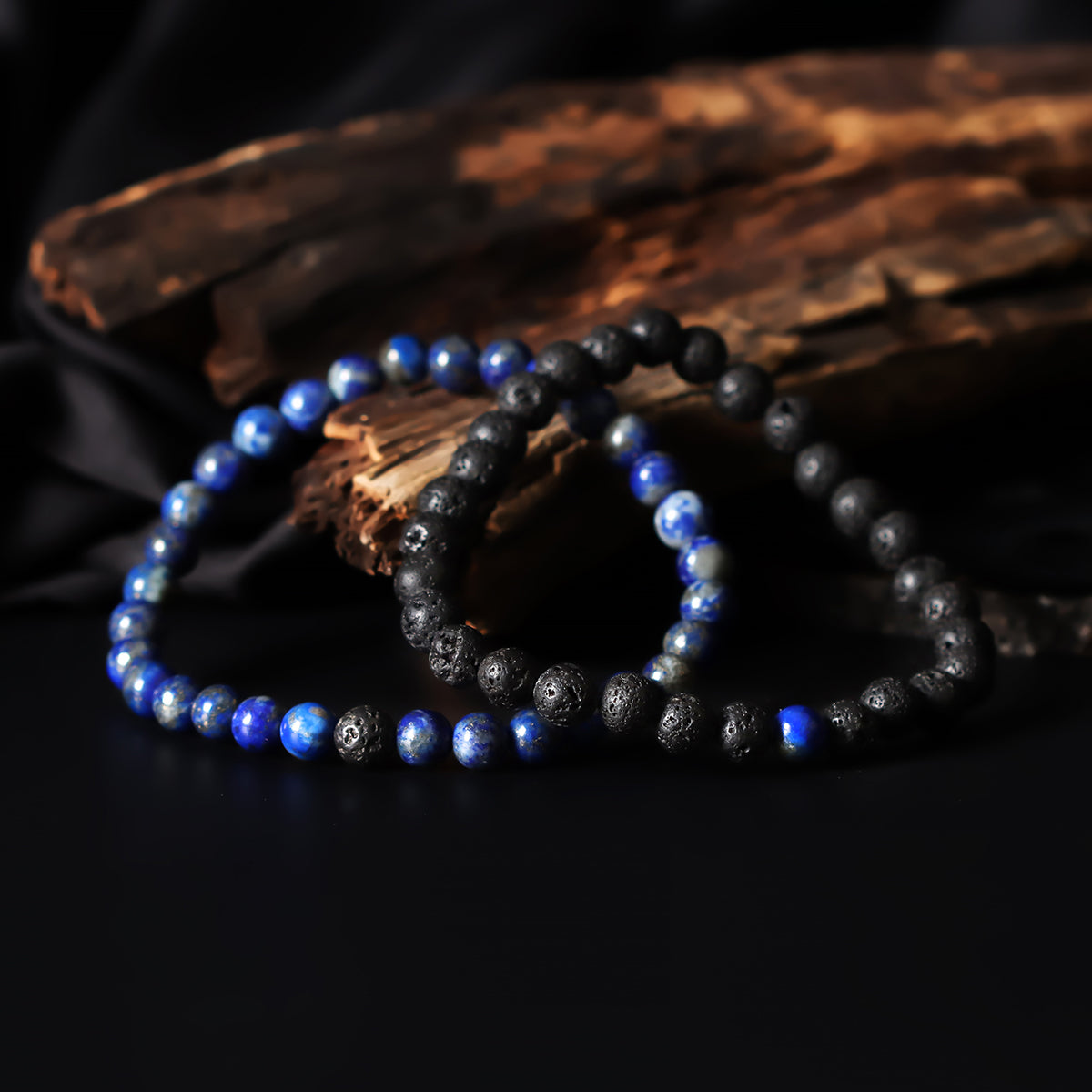 Artistic close-up of the Natural Lapis Lazuli & Lava Gemstone Bracelet. A captivating shot capturing the deep blue hues of Lapis Lazuli and the raw elegance of lava gemstones, creating a unique and eye-catching composition