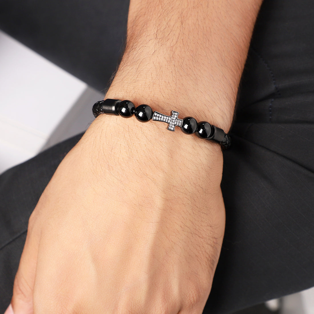 Wrist shot of the bracelet stylishly paired with an edgy outfit, capturing its unique charm