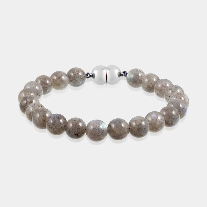 A close-up view of a bracelet made with smooth round labradorite gemstone beads, showcasing their captivating gray hues.