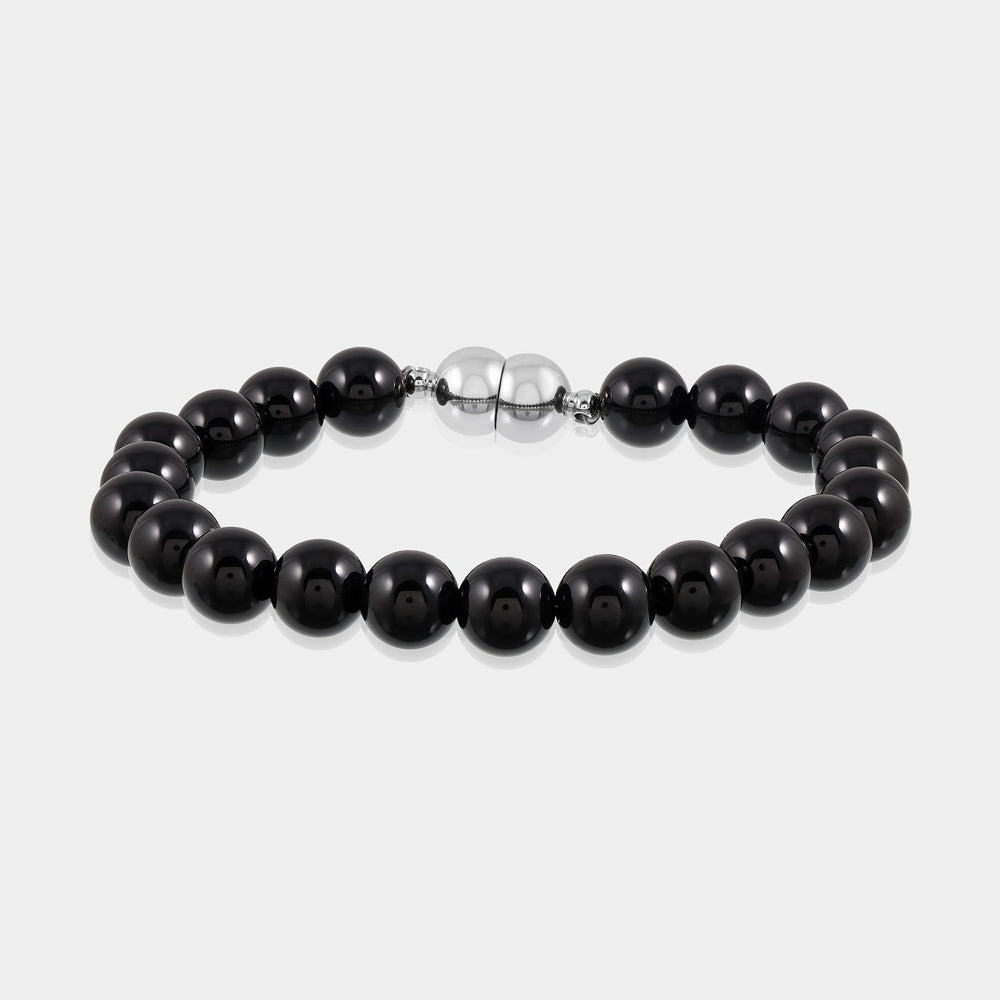 A close-up of a handmade bracelet featuring smooth round black onyx gemstone beads, showcasing its classic and elegant appeal.