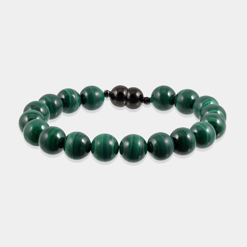 A close-up of a handmade bracelet featuring smooth round malachite gemstone beads, showcasing their rich and vibrant green color.