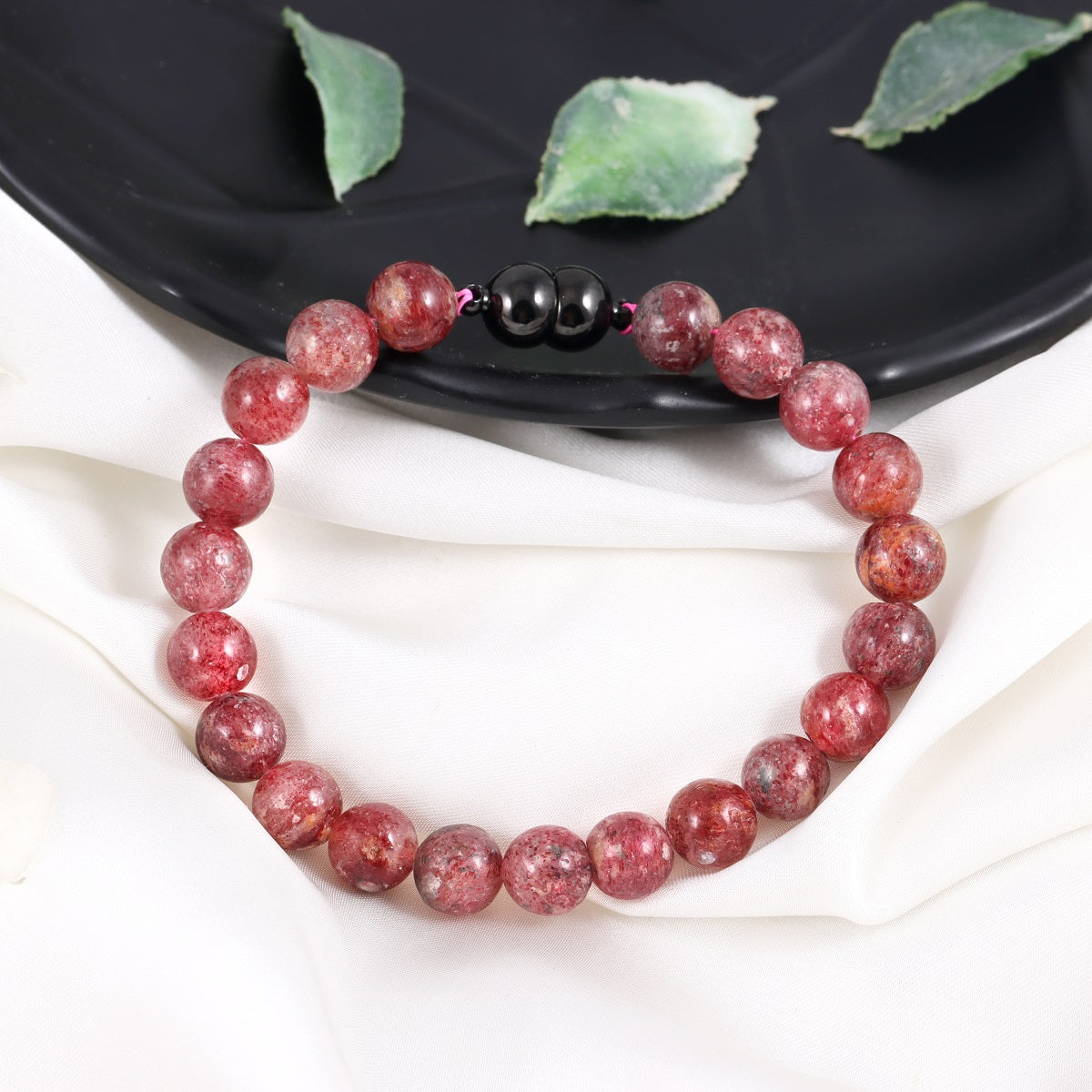 An image featuring the strawberry quartz gemstones alongside keywords like love, emotional healing, and compassion, symbolizing their metaphysical properties.