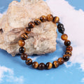 An image featuring the golden tiger's eye gemstones alongside keywords like confidence, protection, and personal power, symbolizing their metaphysical properties.