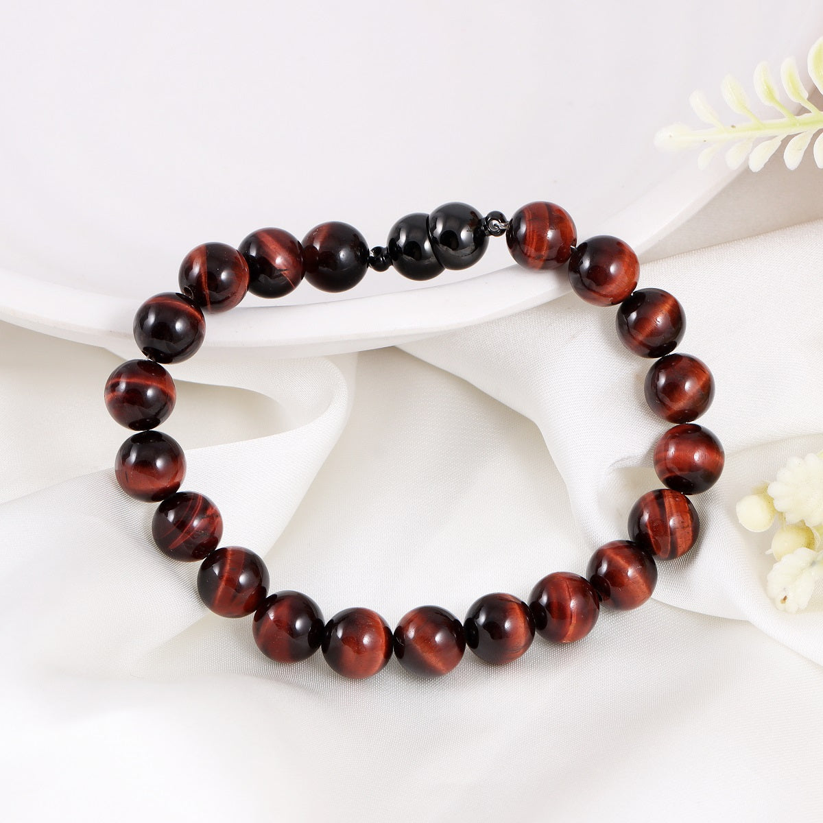 An image featuring the red tiger's eye gemstones alongside keywords like motivation, confidence, and empowerment, symbolizing their metaphysical properties.