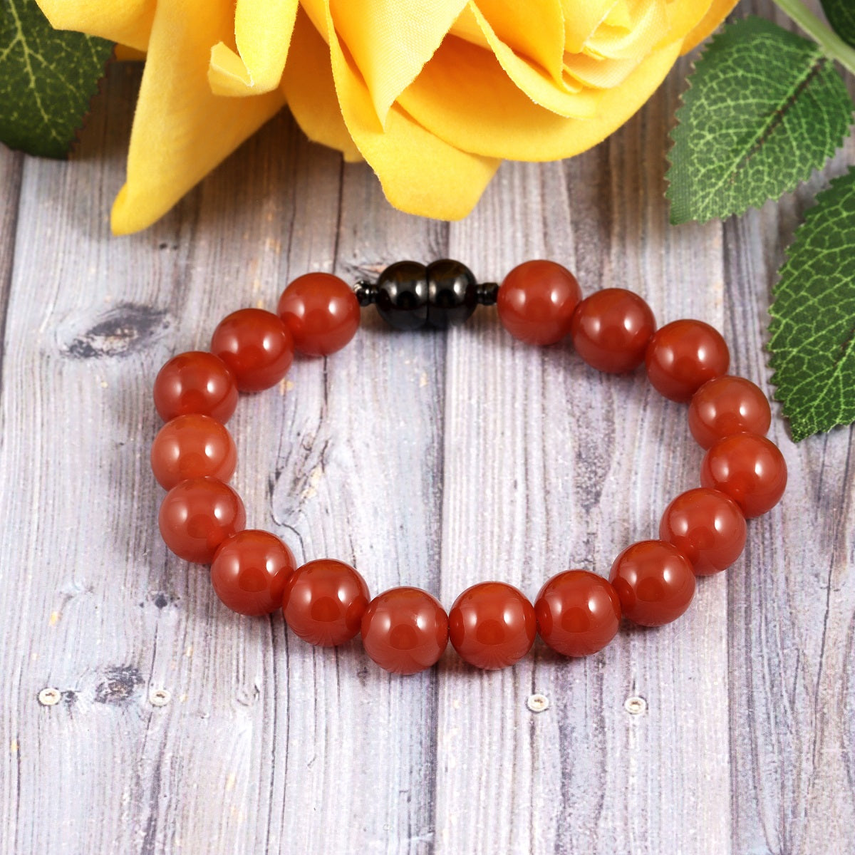 An image featuring the red onyx gemstones alongside keywords like vitality, strength, and empowerment, symbolizing their metaphysical properties.