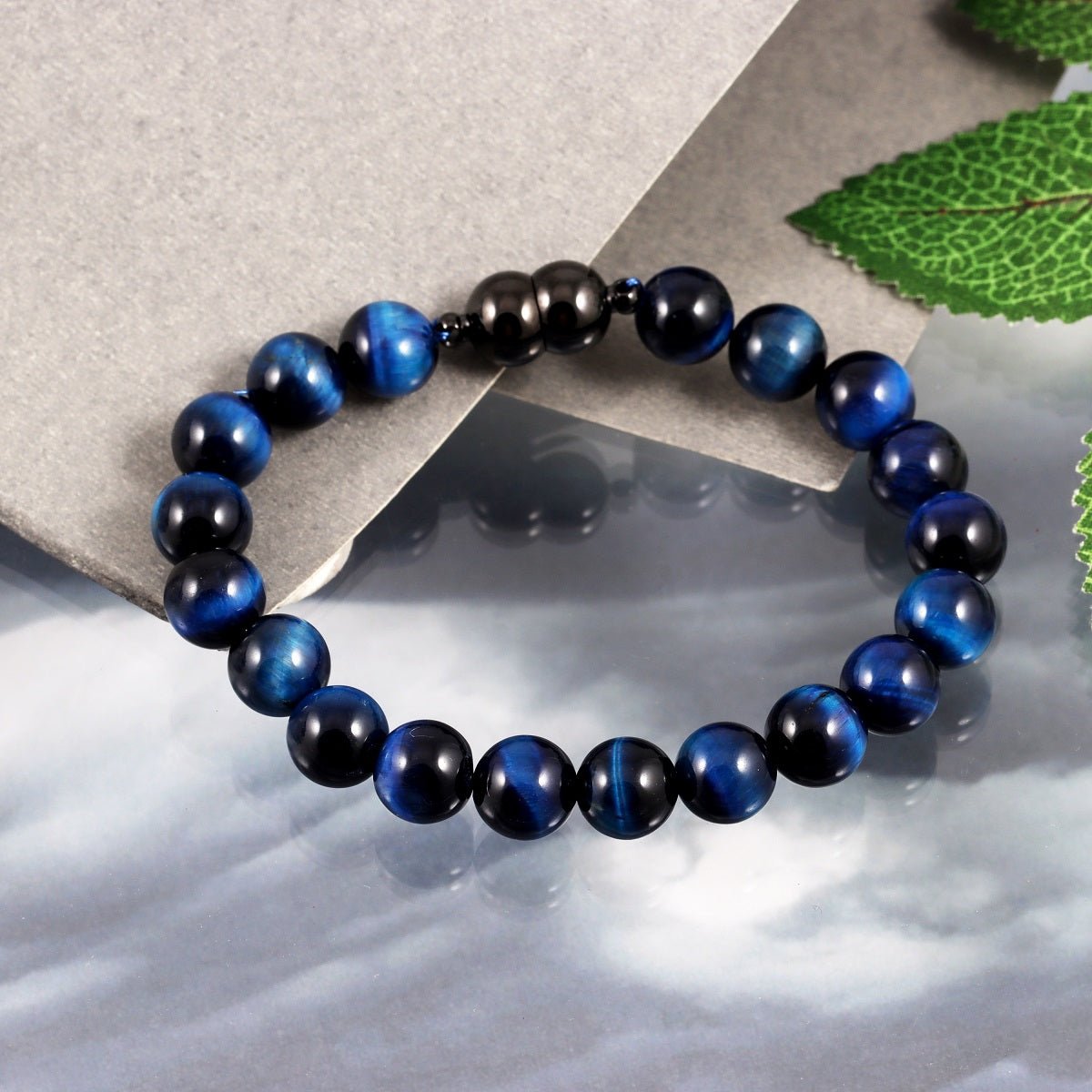 An image featuring the blue tiger's eye gemstones alongside keywords like clarity, intuition, and protection, symbolizing their metaphysical properties.