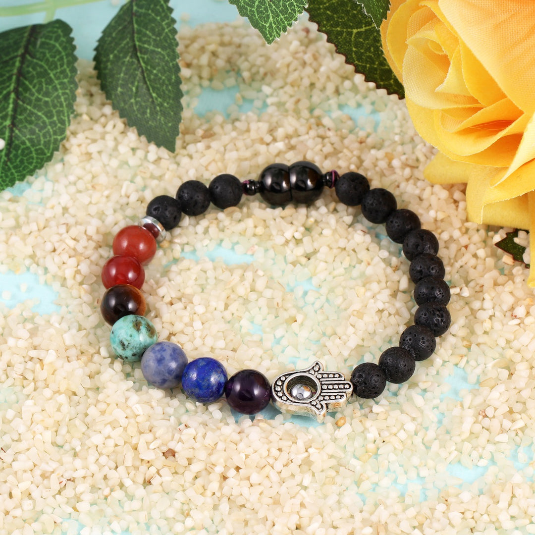 A captivating lava bead and 7 chakra stone bracelet, highlighted by a Hamsa Hand emblem