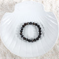 Elegantly packaged Black Banded Agate 8mm Bracelet, ready to be worn as a stylish and meaningful accessory for strength and grounding