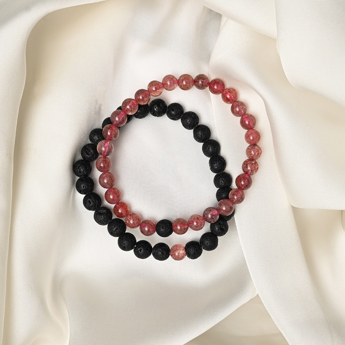 Detailed close-up showcasing the intricate beauty of Strawberry Quartz's red tones and the contrasting black Lava gemstones.
