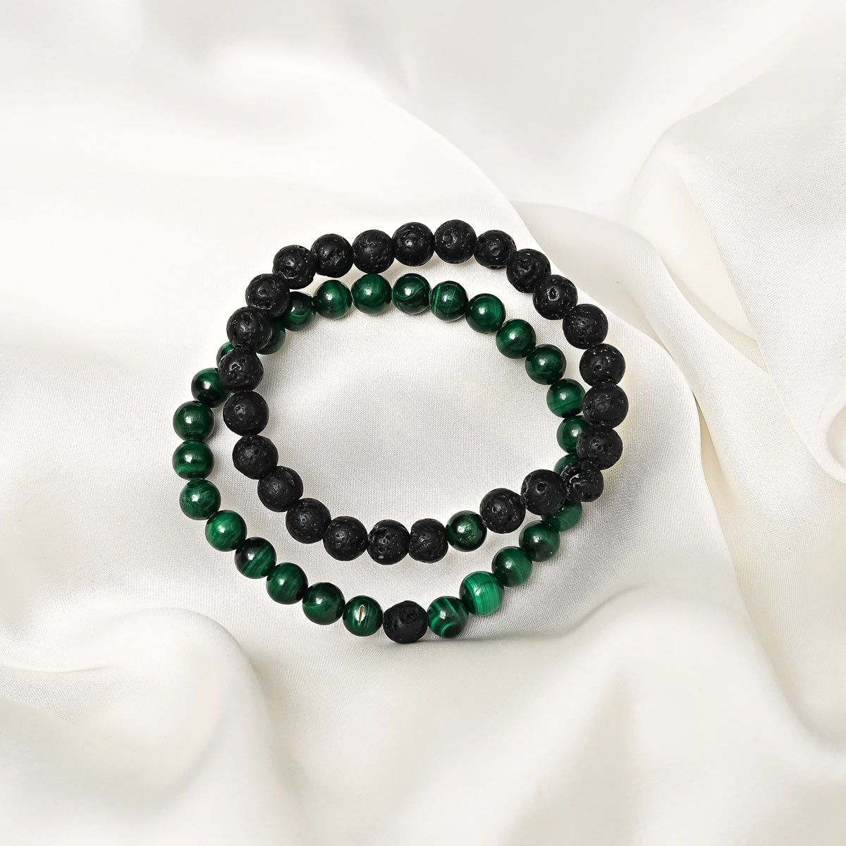 Detailed close-up showcasing the intricate beauty of green Malachite and black Lava gemstones in our exquisite bracelet.