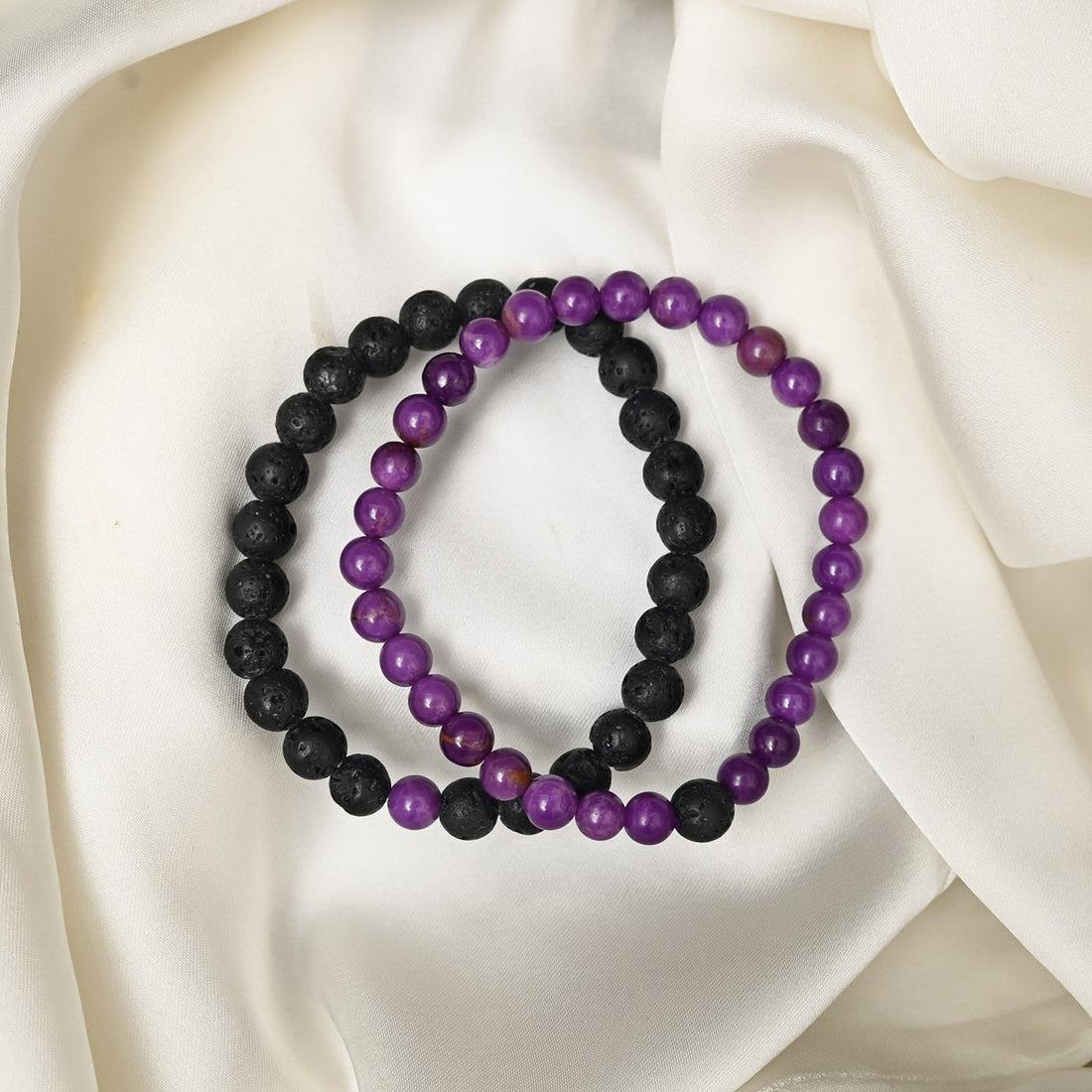 Detailed close-up showcasing the intricate beauty of Lepidolite's purple hues and the contrasting black Lava gemstones.