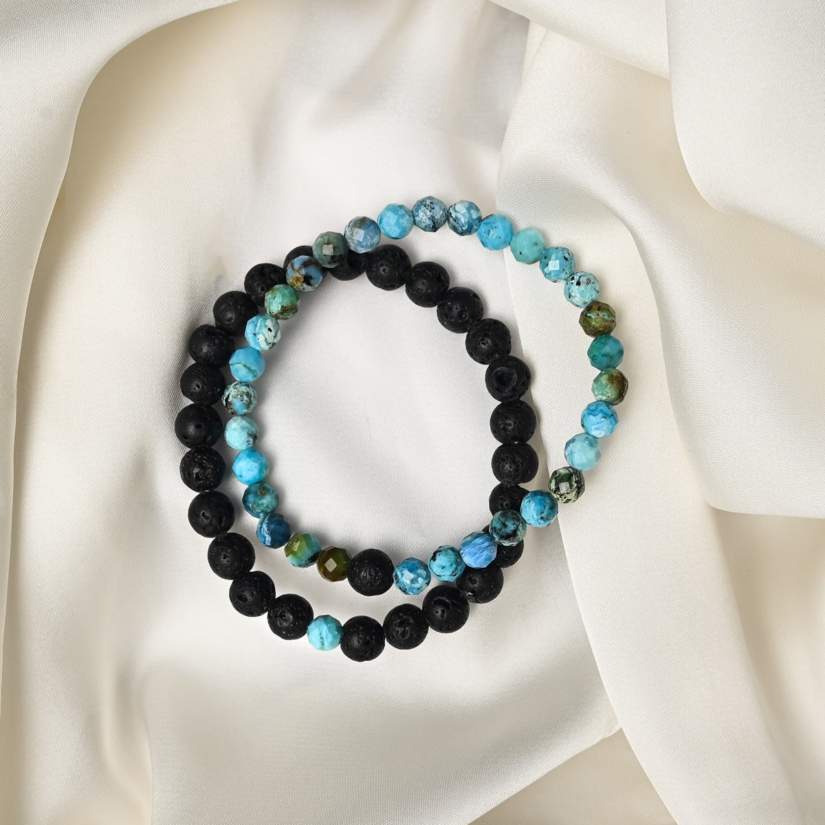 Detailed close-up showcasing the intricate beauty of Opaline's faceted round beads and the contrasting black Lava gemstones.
