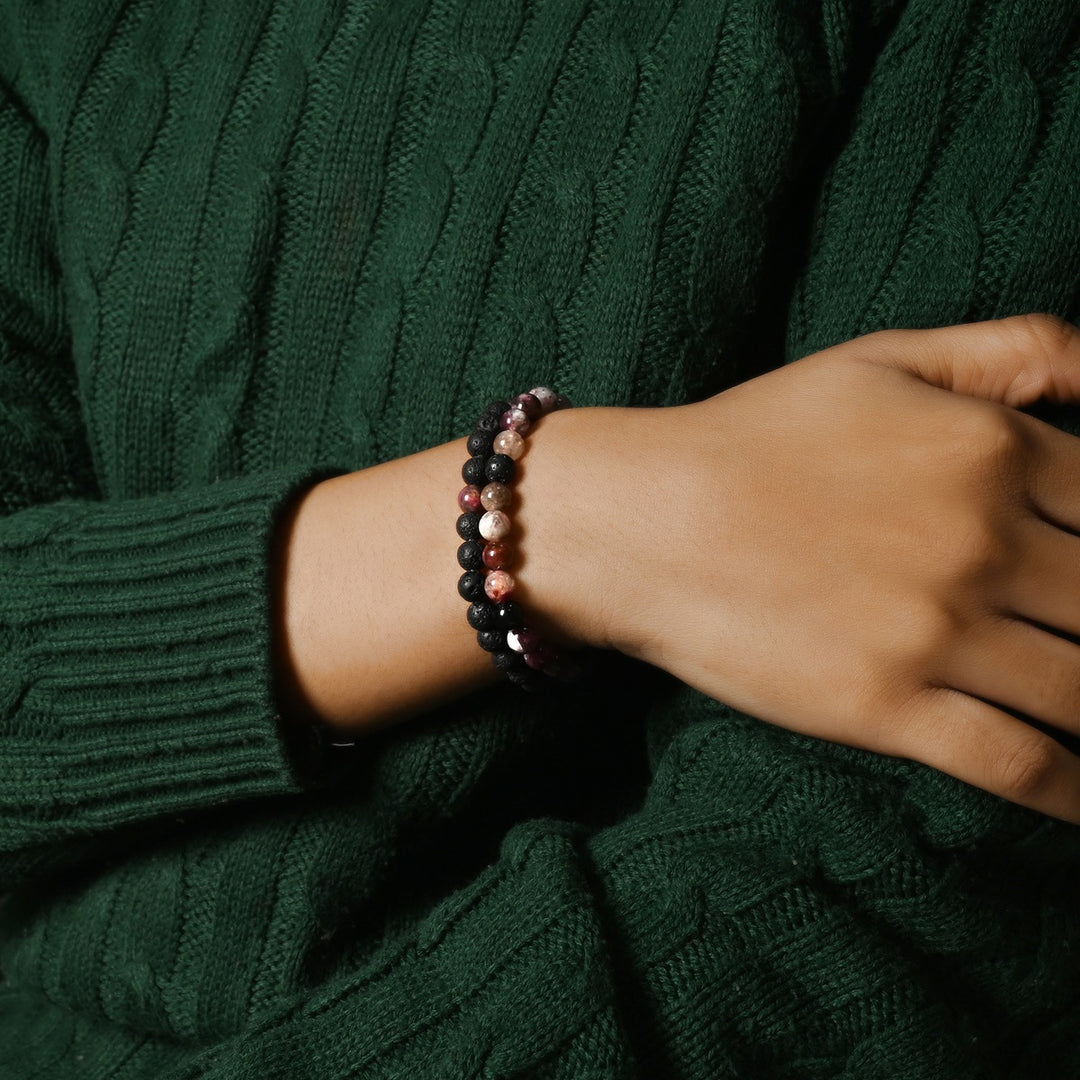 Elegant Flower Tourmaline and Lava gemstone bracelet adorning the wrist, a harmonious blend of vibrant energy and grounding effects.