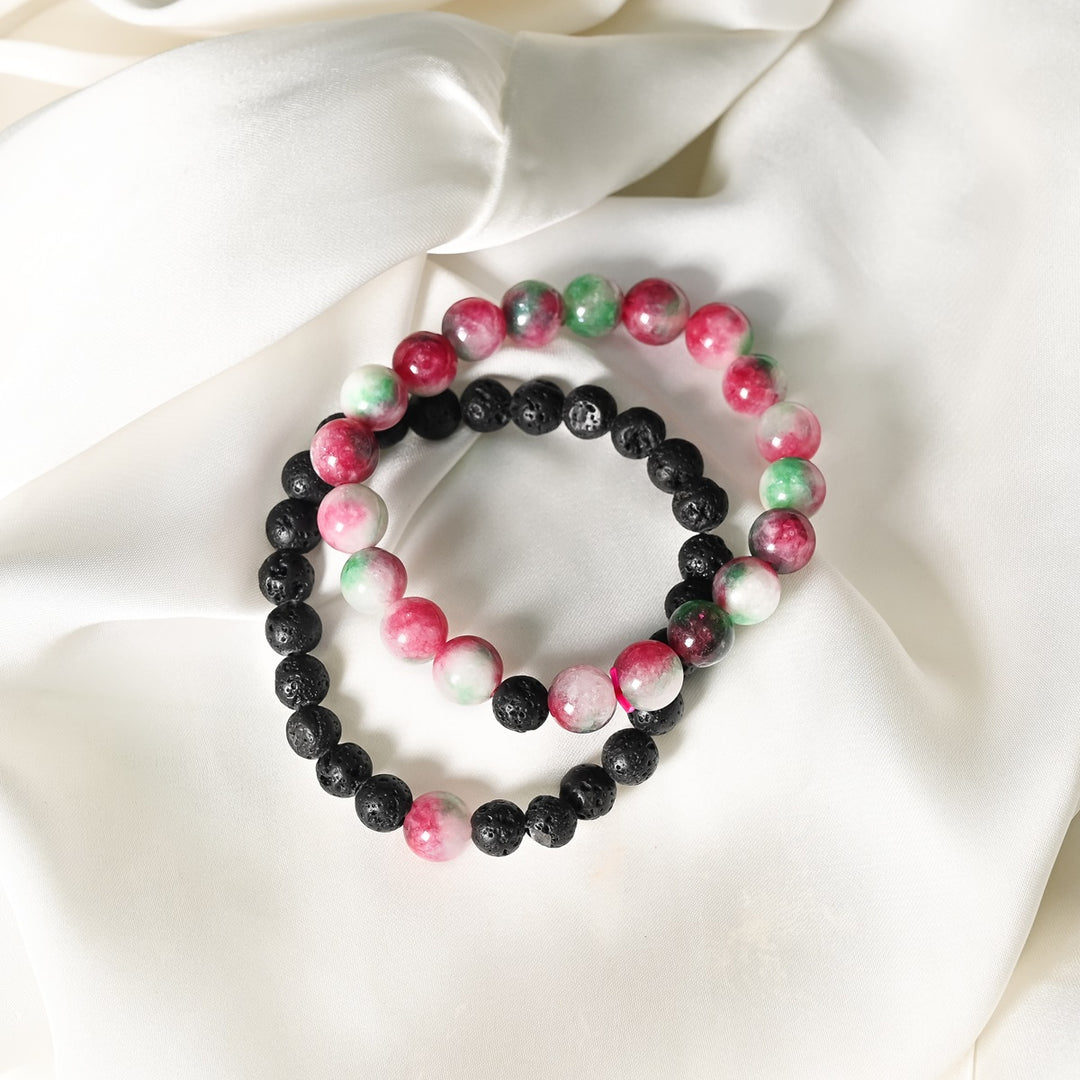 Detailed close-up showcasing the intricate beauty of Watermelon Quartz's smooth round beads and the contrasting black Lava gemstones.