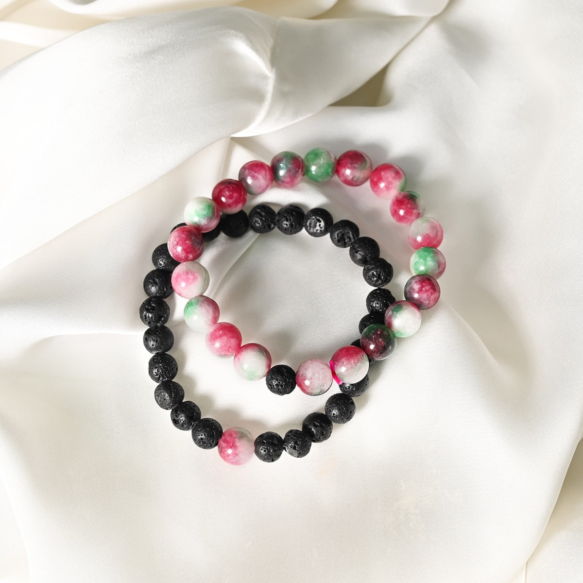 Detailed close-up showcasing the intricate beauty of Watermelon Quartz's smooth round beads and the contrasting black Lava gemstones.
