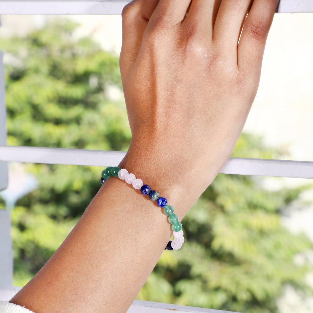 Stylish wrist shot featuring the Vitality Harmony Trio Bracelet, adorned with Lapis Lazuli, Rose Quartz, and Green Aventurine gemstone beads for a harmonious blend of style and well-being.