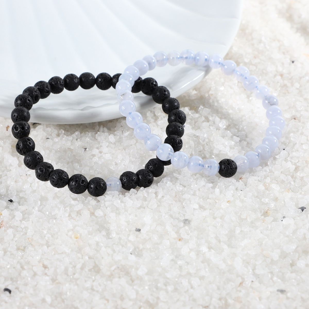 Detailed view of a 6mm Lava bead, highlighting the porous texture for aromatherapy infusion and symbolizing grounding strength in the bracelet combo