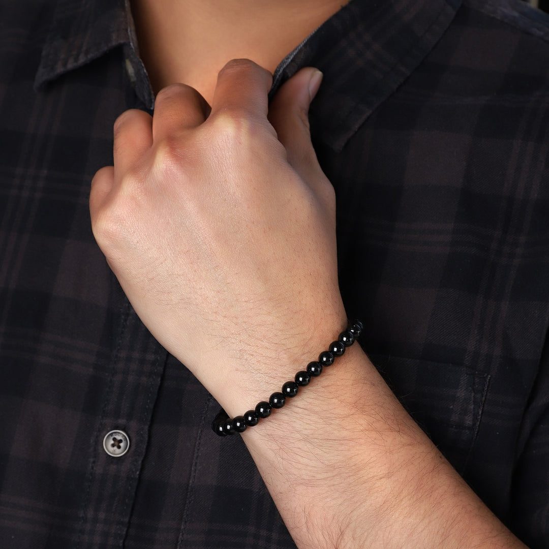 Stylish Black Tourmaline Stretch Bracelet featuring 6mm beads, a symbol of protection and grounding, elegantly adorning the wrist