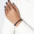 Confident individual wearing the Black Onyx Bracelet, embodying strength, resilience, and a sense of inner balance