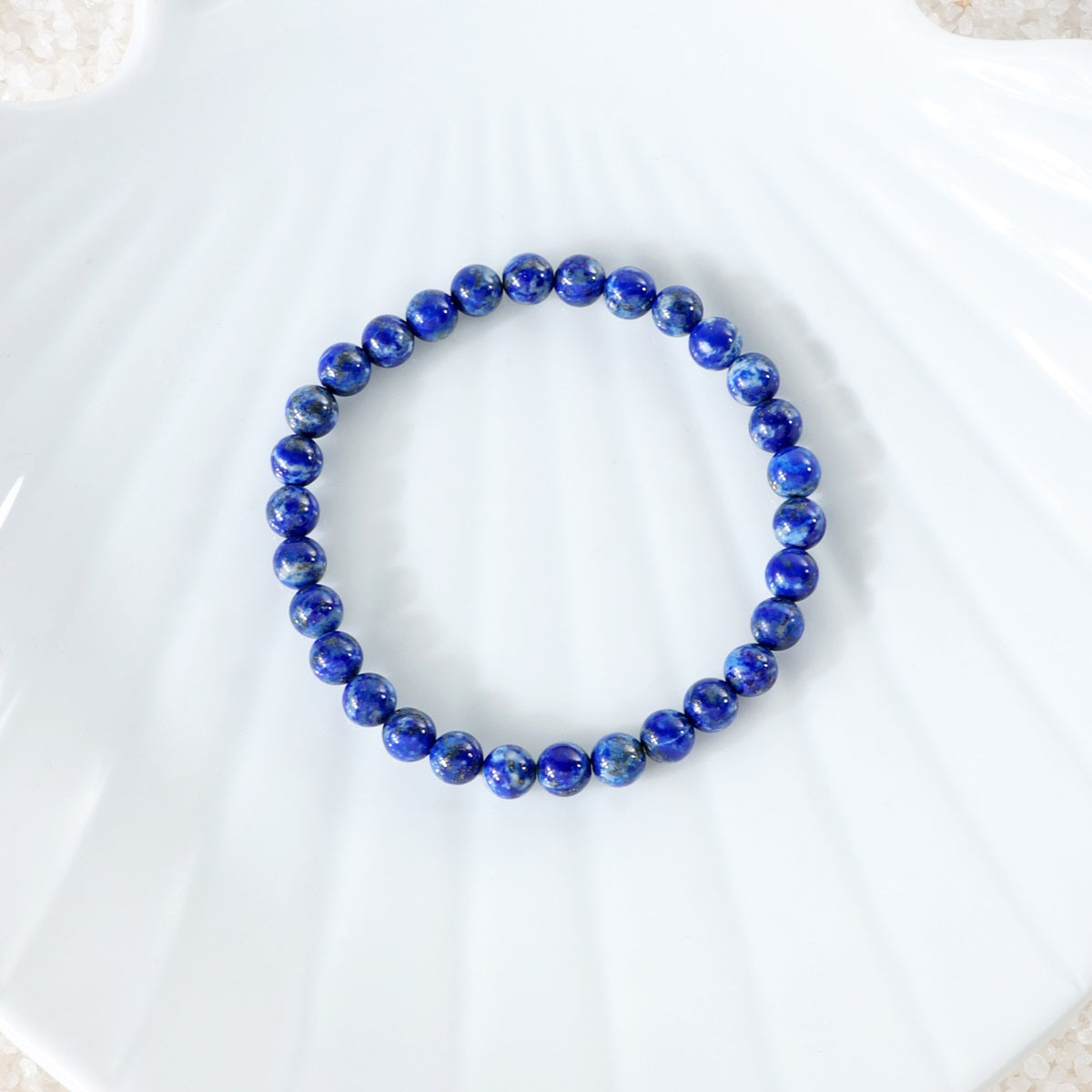Detailed view of a 6mm Lapis Lazuli bead, showcasing the deep blue hue and gold flecks, highlighting the exquisite craftsmanship in the bracelet