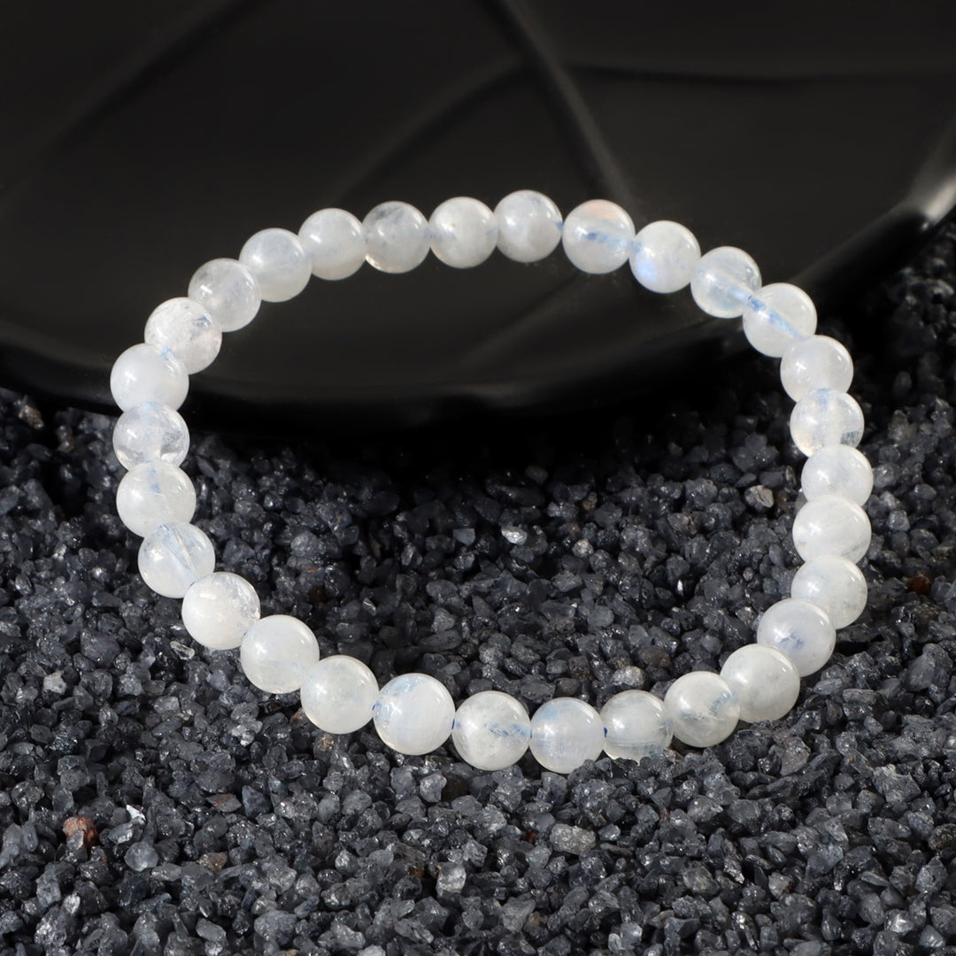 Detailed view of a 6mm Rainbow Moonstone bead, showcasing the iridescent hues and ethereal qualities in the bracelet