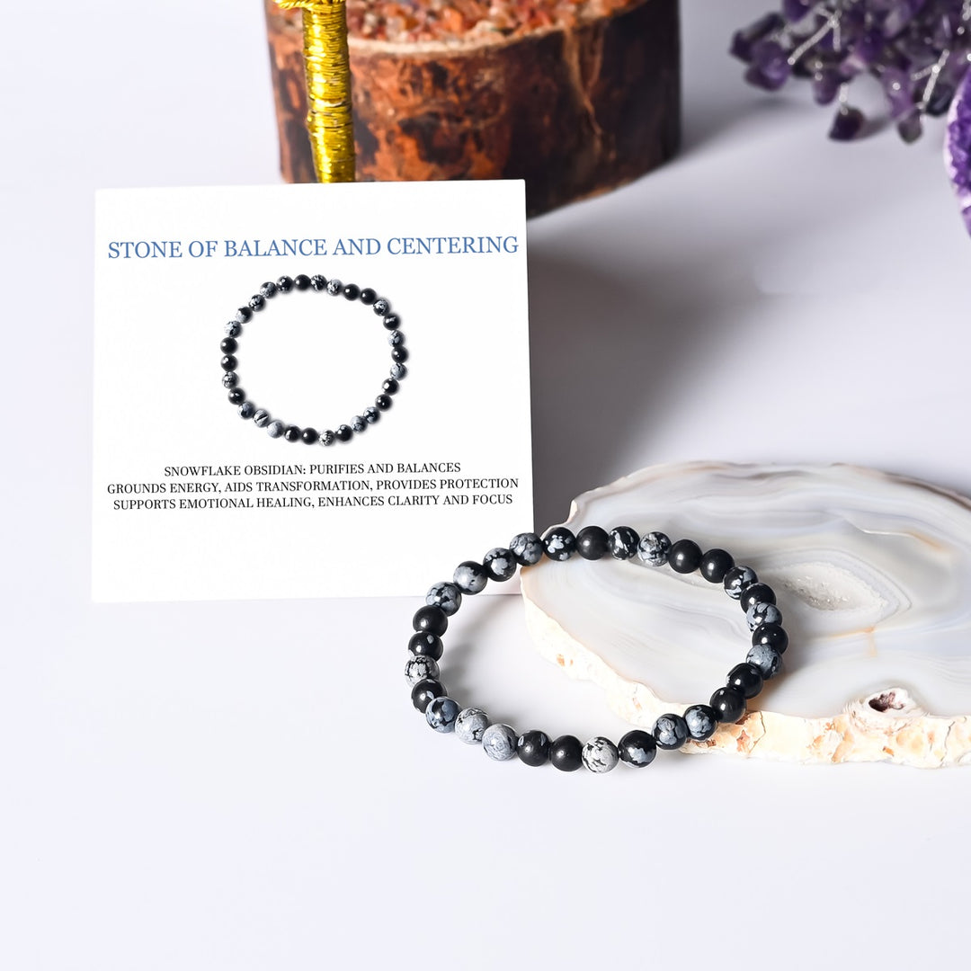 Artistic representation symbolizing balance, featuring the Snowflake Obsidian Bracelet as a source of grounding energies for a harmonious and centered lifestyle