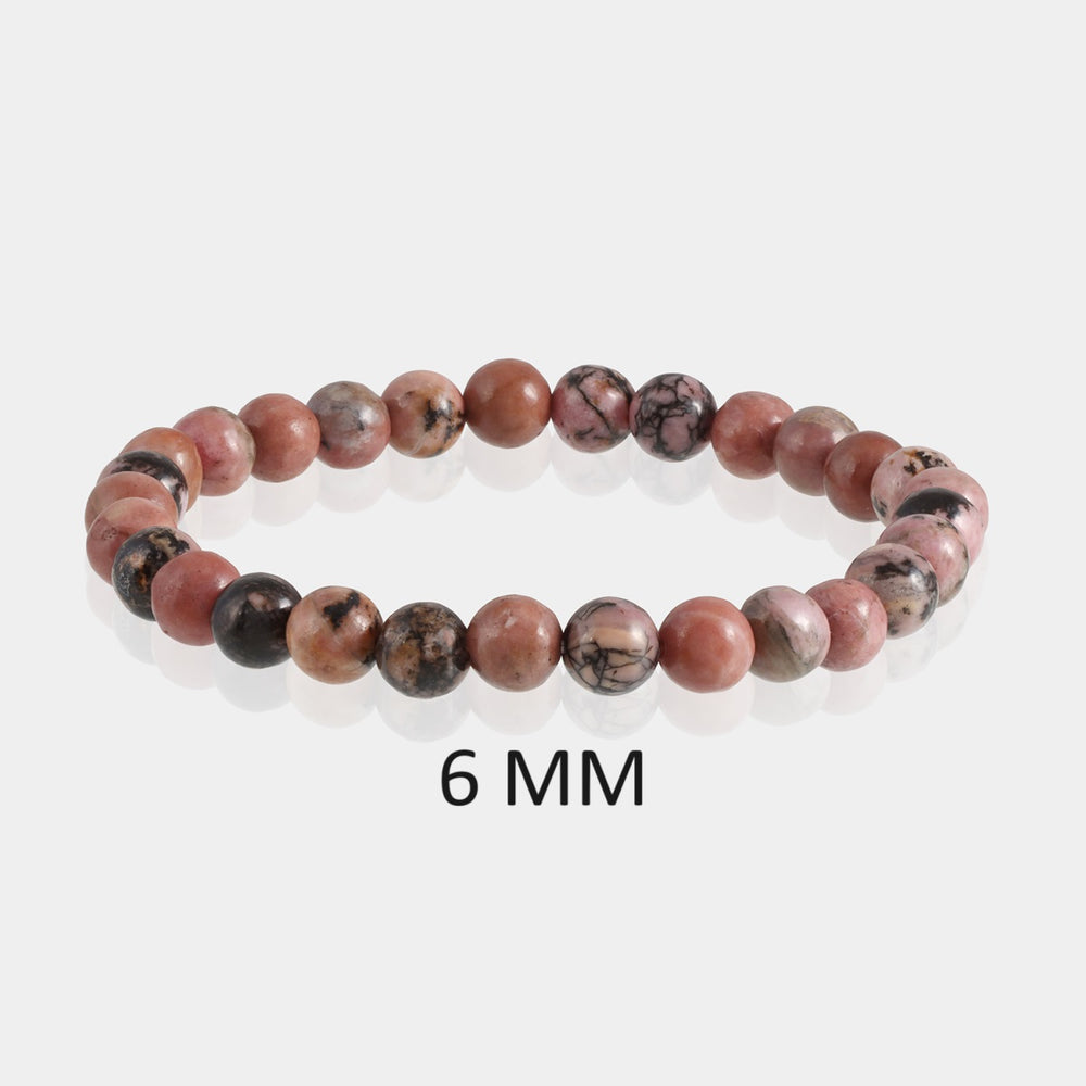 Detailed image showcasing the exquisite 6mm smooth round beads of Rhodonite, emphasizing the subtle pink hues and characteristic black veins associated with love and compassion