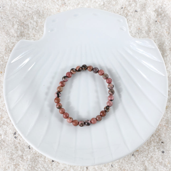 Symbolic image representing the empowering connection with the transformative energies of love and compassion associated with the Rhodonite Bracelet