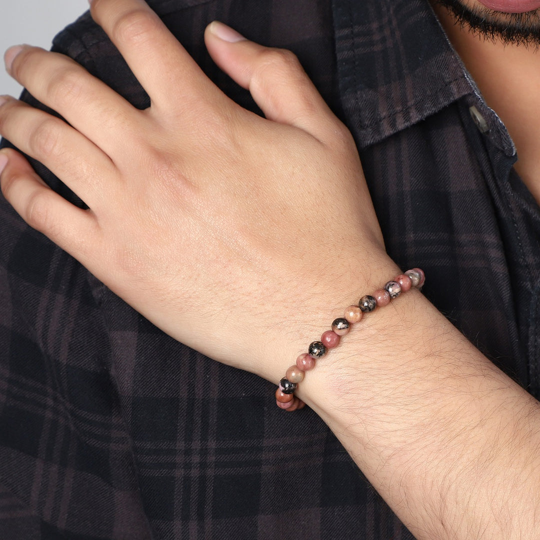 Stylish view of the Rhodonite Stretch Bracelet with 6mm smooth round beads, radiating love and compassion for a fashionable and emotionally healing accessory