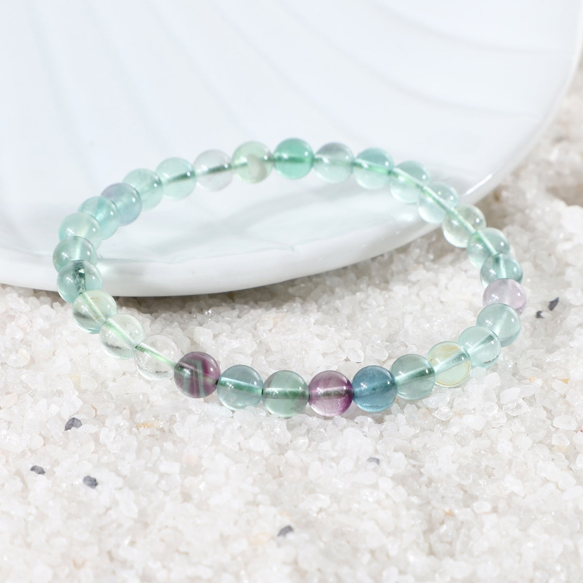 Various styling ideas for the Fluorite Stretch Bracelet, demonstrating its versatility as a chic accessory with transformative energies for personal growth